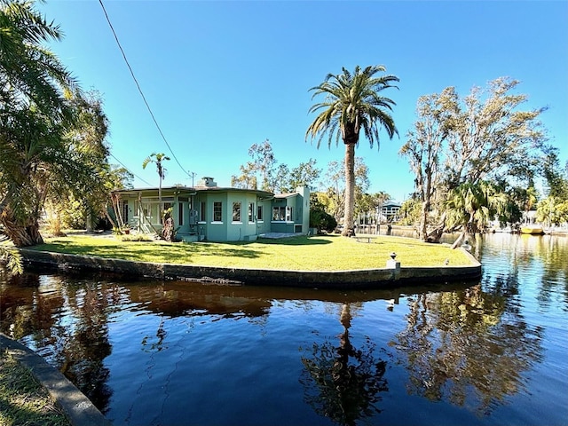 exterior space featuring a yard and a water view