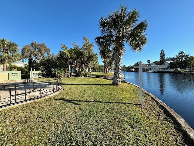 view of community featuring a yard and a water view