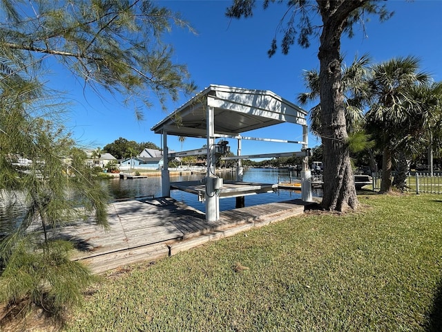 view of dock featuring a water view and a yard