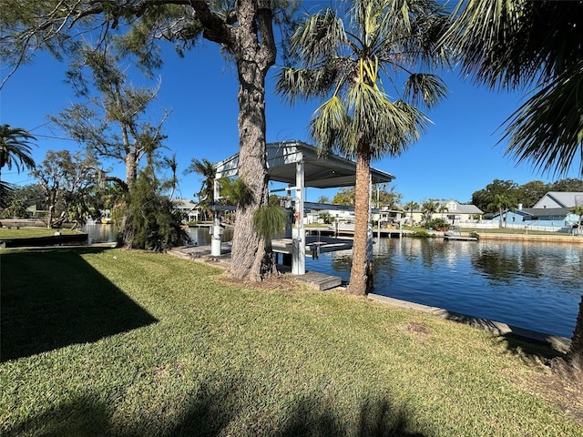 dock area featuring a water view and a lawn