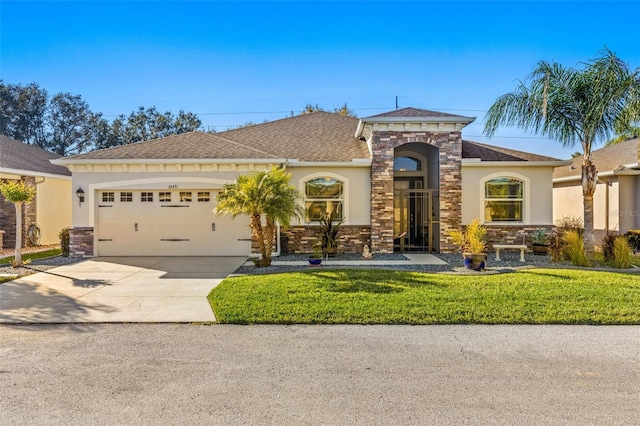 view of front facade with a front yard and a garage