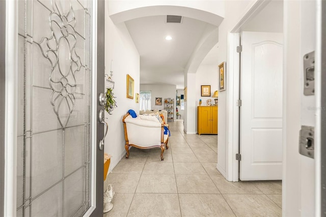 hall featuring light tile patterned floors