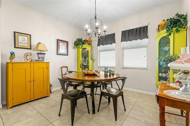 dining area with a chandelier and light tile patterned floors