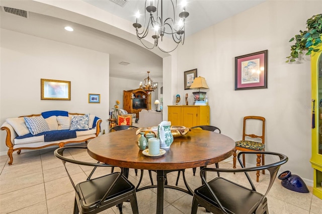 tiled dining area featuring a notable chandelier