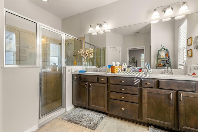 bathroom with tile patterned flooring, vanity, and a shower with shower door