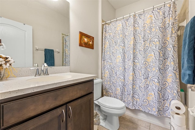 bathroom with tile patterned flooring, vanity, and toilet