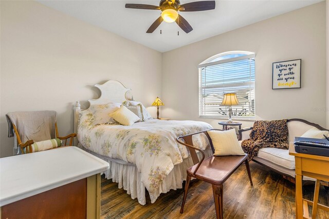 bedroom with dark hardwood / wood-style floors and ceiling fan