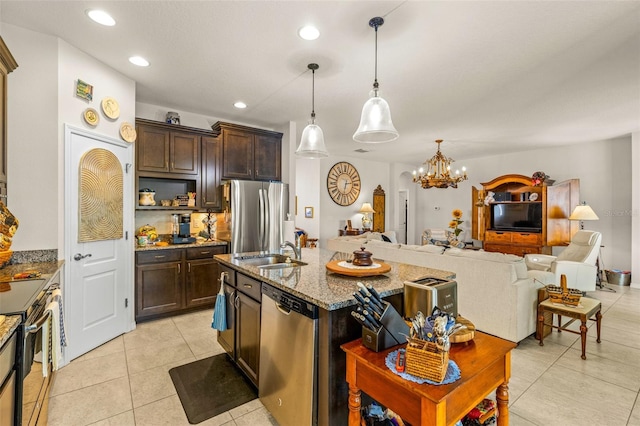 kitchen featuring dark brown cabinetry, stainless steel appliances, light stone counters, a chandelier, and decorative light fixtures