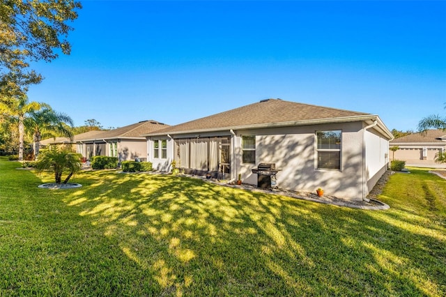 rear view of property with a yard