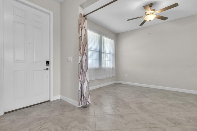 tiled foyer featuring ceiling fan