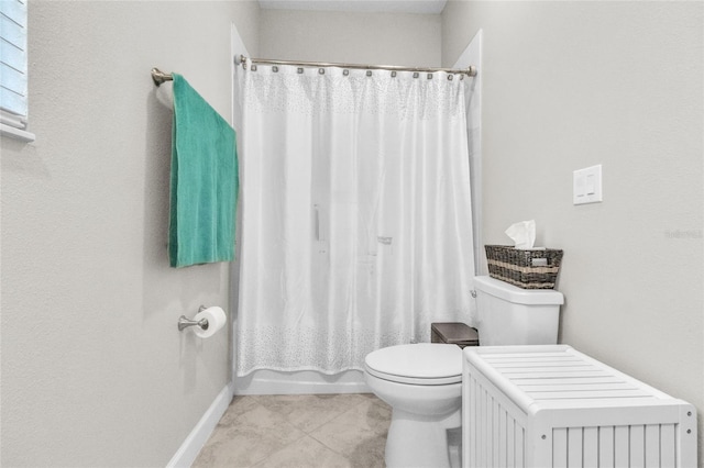 bathroom with tile patterned flooring, shower / bath combination with curtain, and toilet