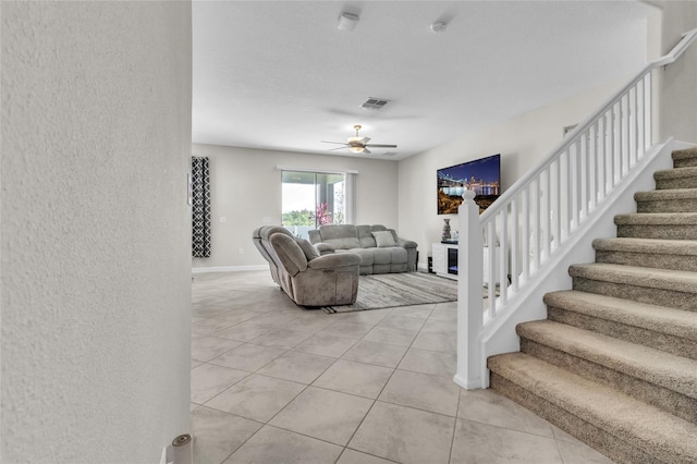 living room featuring light tile patterned floors and ceiling fan