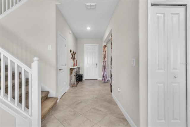 hall with light tile patterned floors