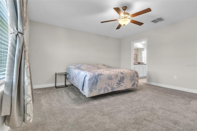 bedroom featuring ensuite bath, ceiling fan, and carpet