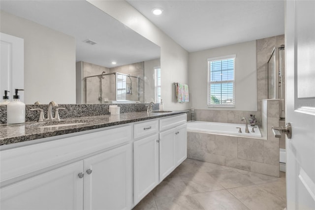 bathroom with independent shower and bath, vanity, and tile patterned floors