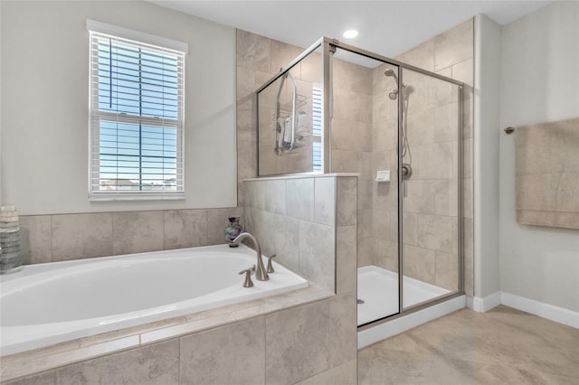 bathroom with separate shower and tub