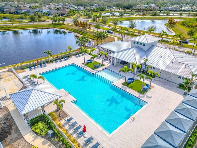 view of pool featuring a water view and a patio area