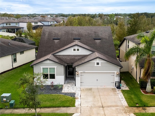 view of front of house with a front yard and a garage