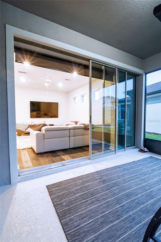 living room with a textured ceiling and hardwood / wood-style flooring