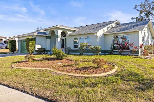 view of front facade with a garage and a front lawn