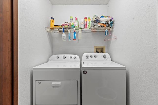 laundry area featuring washer and clothes dryer and a textured ceiling