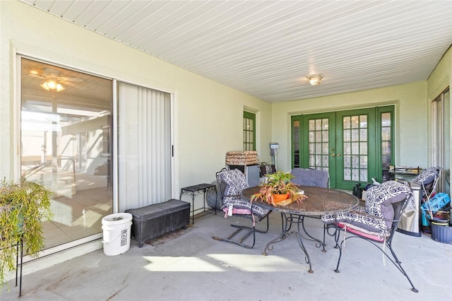 sunroom / solarium featuring french doors