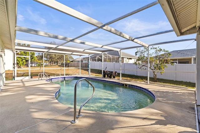 view of swimming pool with glass enclosure and a patio