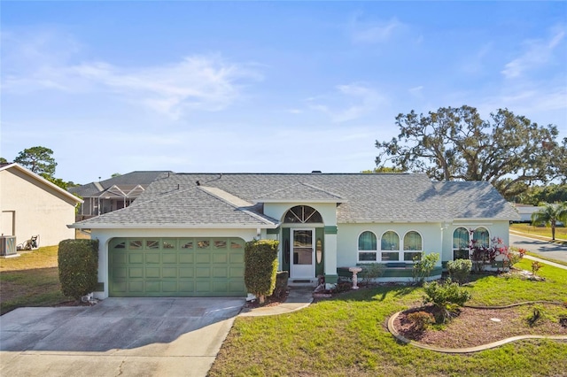 single story home with central AC, a front yard, and a garage