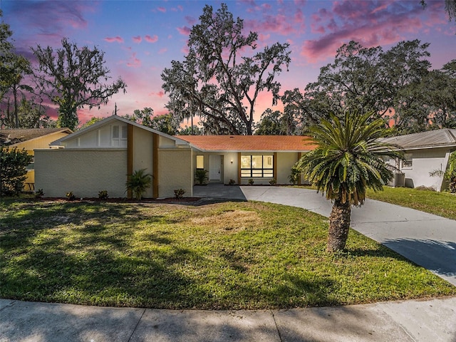 ranch-style home featuring a yard