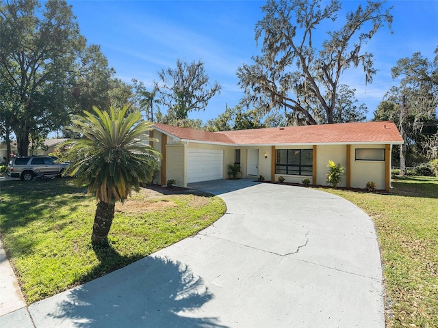 ranch-style house with a garage and a front lawn