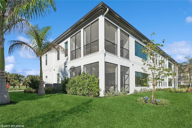 view of side of home with a yard