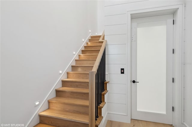 staircase with wood-type flooring