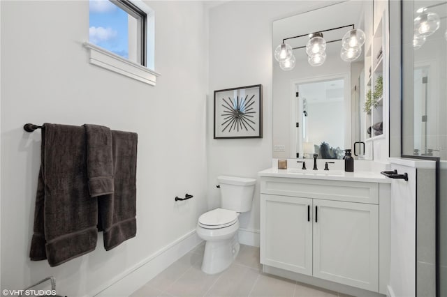 bathroom featuring tile patterned flooring, vanity, and toilet