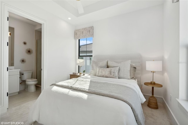 bedroom featuring ensuite bathroom, ceiling fan, and light colored carpet