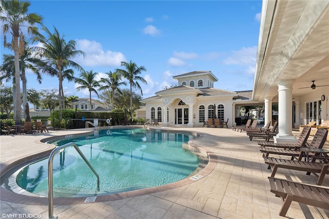 view of swimming pool featuring french doors, a patio, and ceiling fan