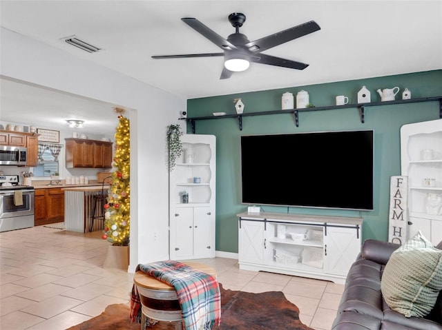 living room with ceiling fan and light tile patterned floors