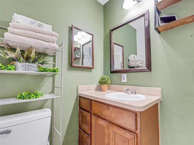 bathroom featuring vanity and toilet