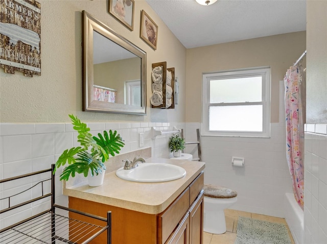 full bathroom with vanity, tile walls, and toilet