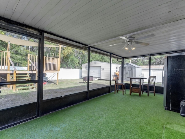 unfurnished sunroom with ceiling fan and wooden ceiling