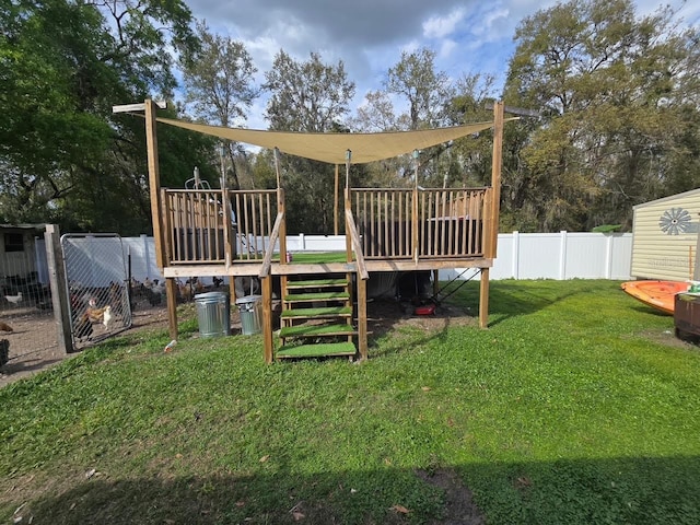 view of playground featuring a yard, a fenced backyard, and a wooden deck