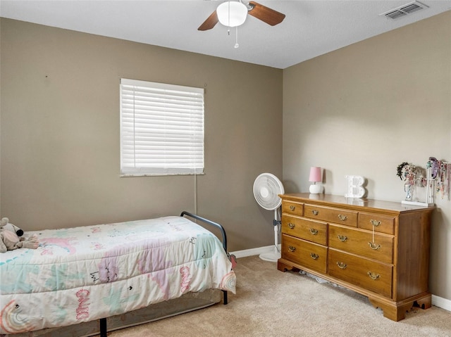 bedroom with light colored carpet, visible vents, ceiling fan, and baseboards