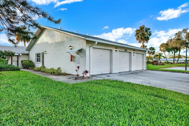 view of home's exterior with a yard and a garage