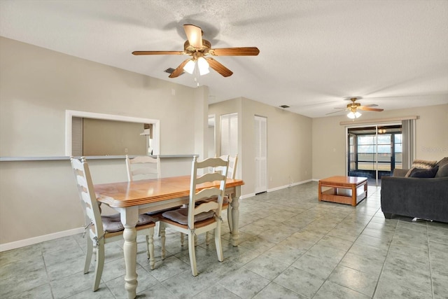 dining room featuring ceiling fan and a textured ceiling