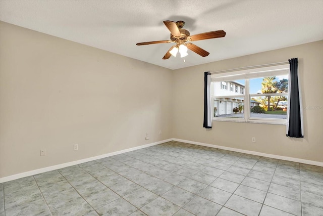 spare room with ceiling fan and a textured ceiling