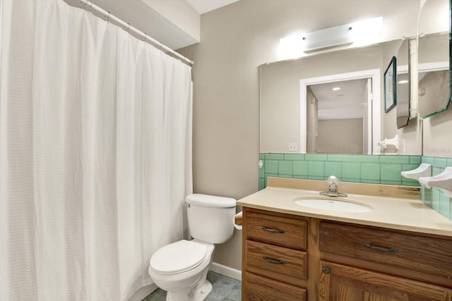 bathroom featuring decorative backsplash, vanity, and toilet