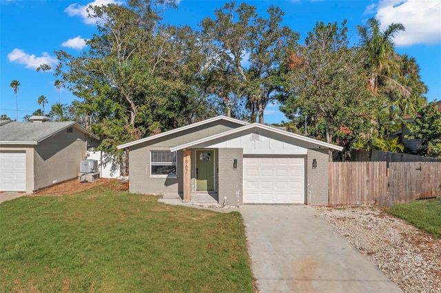 ranch-style house with a garage and a front lawn