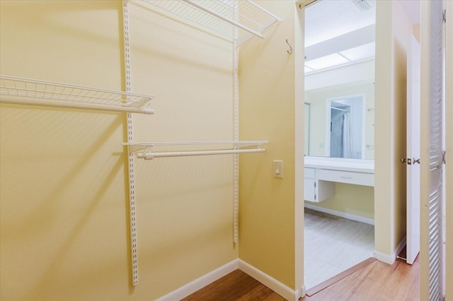 1808 Cypress Trace Dr Unit 1808, Safety Harbor, FL 34695 - walk in closet featuring wood finished floors