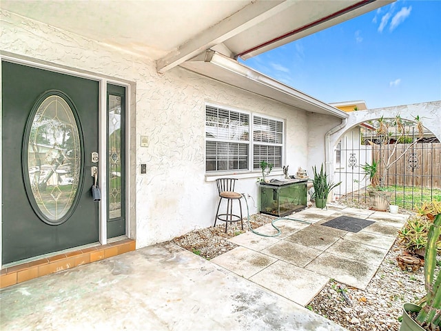 entrance to property with a patio