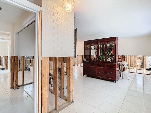 hall featuring a chandelier and light tile patterned floors