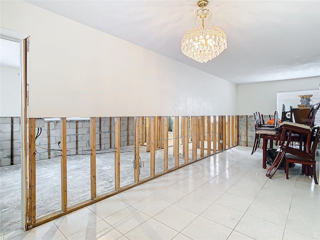 interior space with a notable chandelier and light tile patterned flooring